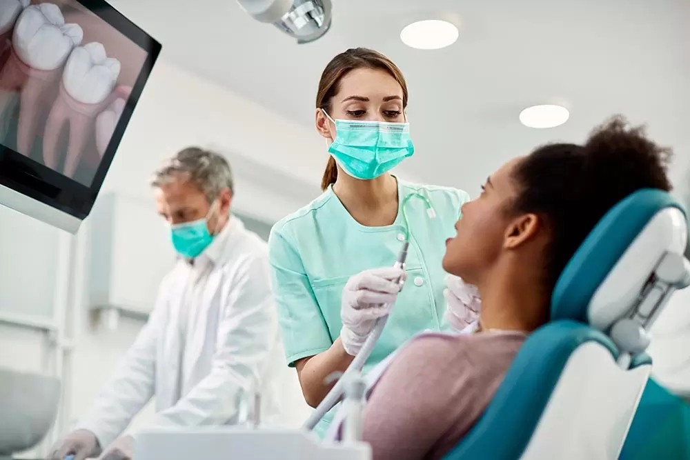 young nurse preparing patient for dental procedure 2023 02 02 18 49 55 utc